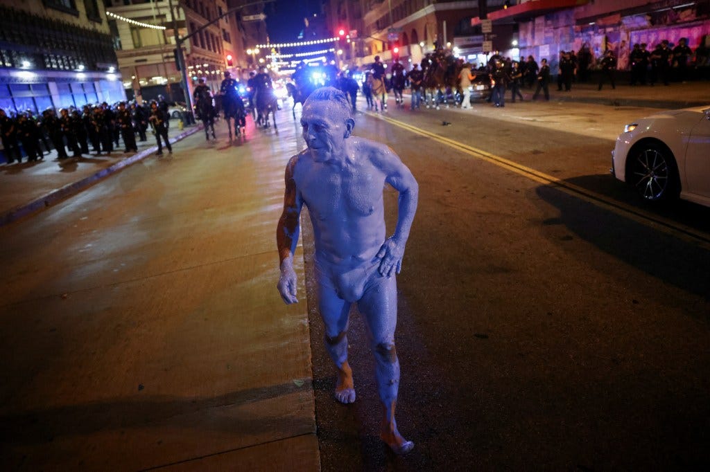 The blue man took off as police closed in him him, with other revelers getting caught up by the advancing officers