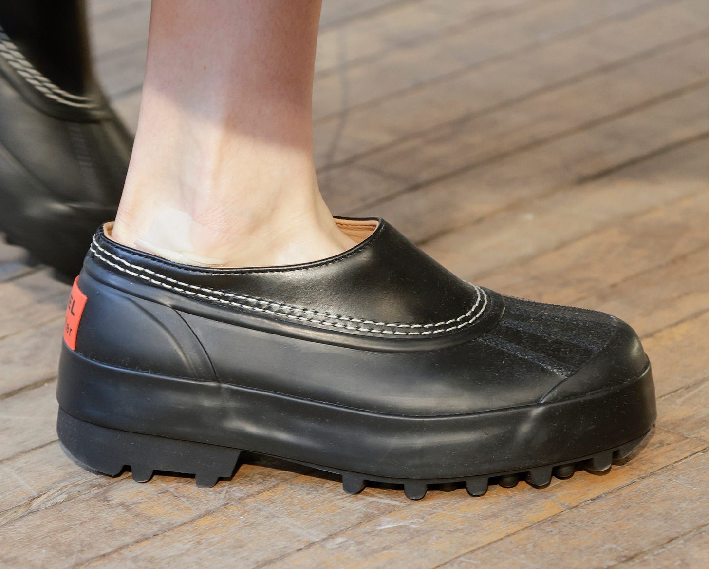 Image may contain Clothing Footwear Shoe Sneaker Person and Clogs