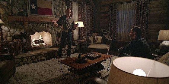 Bonham in front of fire talking hot to Jared Padalecki on Walker set.