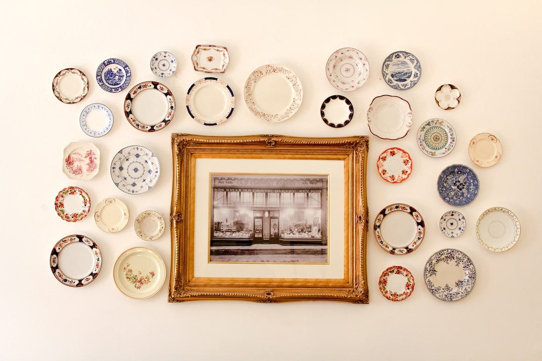 photo frame near assorted-color ceramic dishes photo frame near assorted-color ceramic dishes