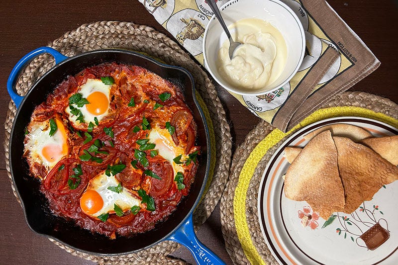 Baked egg shakshuka, flatbread and labneh with honey.