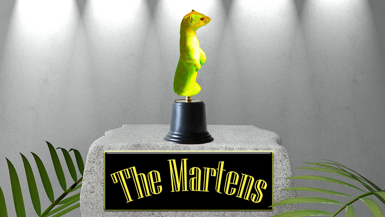 An award of a golden weasel sits on a pedestal bathed in stage lights as "The Martens" is written on a plaque in front.
