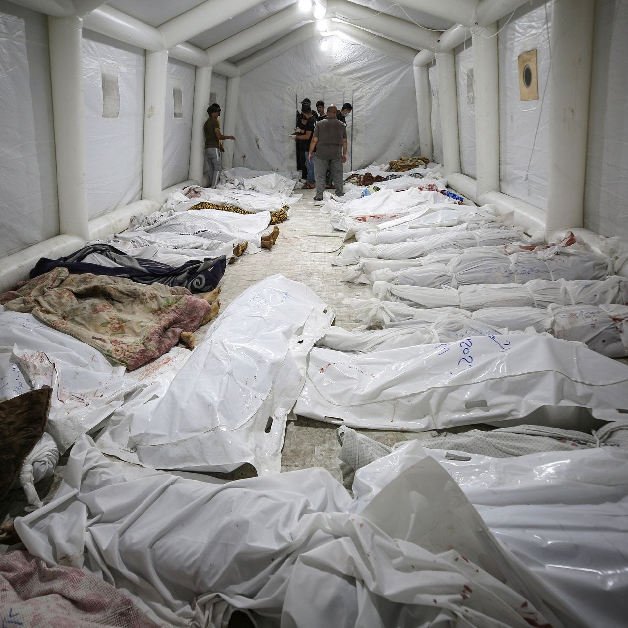 Bodies of Palestinians who were killed in a blast at the Al-Ahli Arab Hospital in Gaza.