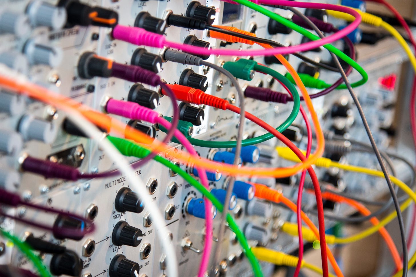 Close up photo of machine with many ports connected with colorful wires.