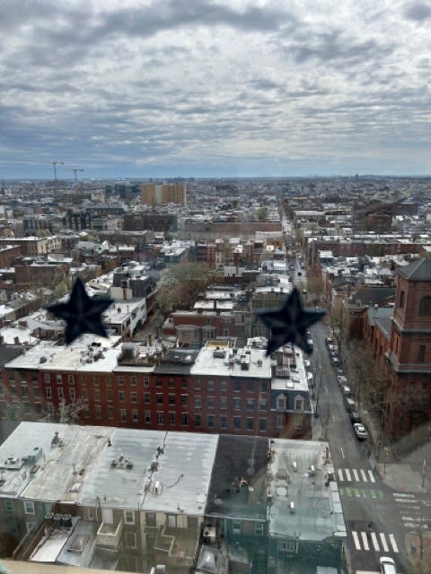 A view of Center city Philadelphia from the 16th floor of a building. The city looks like a model of itself, with delineated streets, and endless brick buildings.
