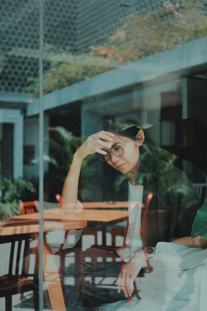 Disappointed girl sitting at a table.