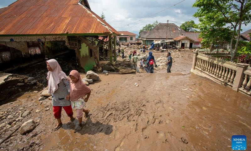 People walk in a damaged area after a cold lava flood at Agam regency in West Sumatra, Indonesia, on May 12, 2024. The death toll from lava floods that struck Indonesia's West Sumatra province on Saturday rose to 34, with at least five others missing, a senior official of the local disaster agency said on Sunday. Photo: Xinhua