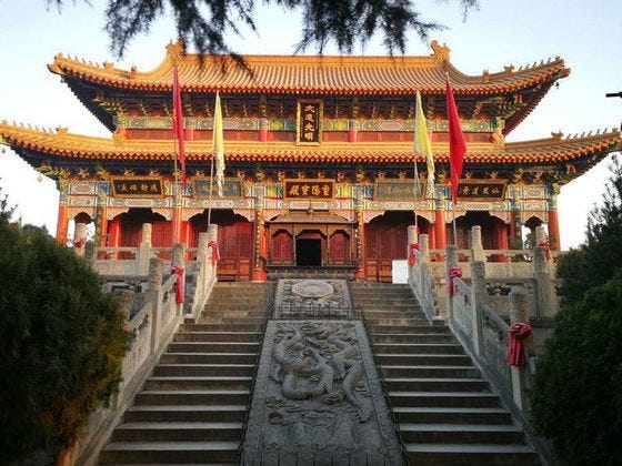 A chinese temple in yellow and gold colors.