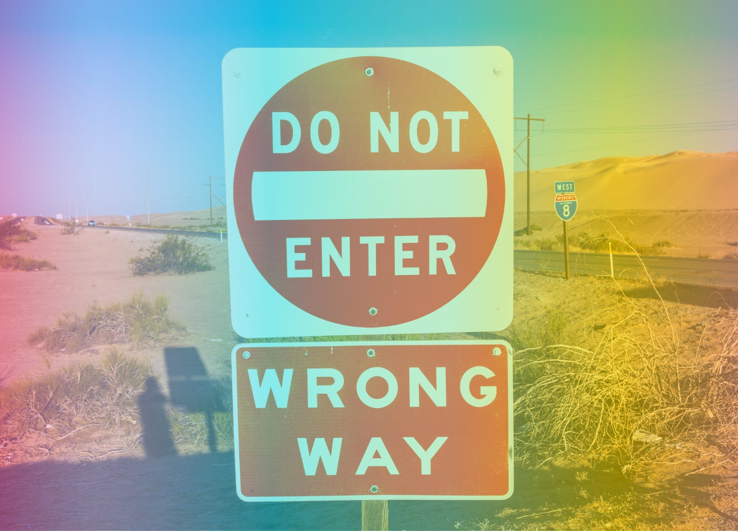 A rainbow-filtered image of signs on the side of the road that say "Do Not Enter" "Wrong Way"