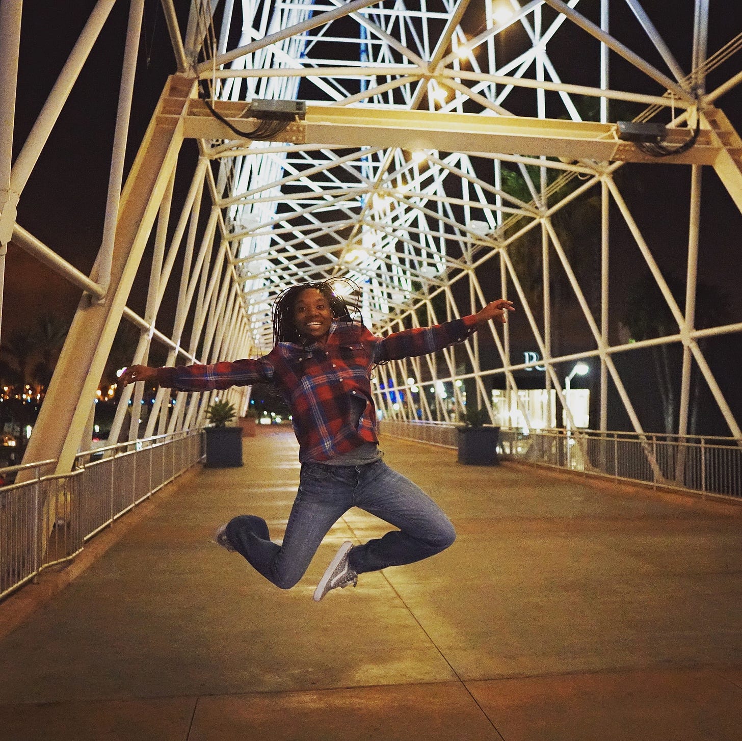 Lula White jumping while on a bridge