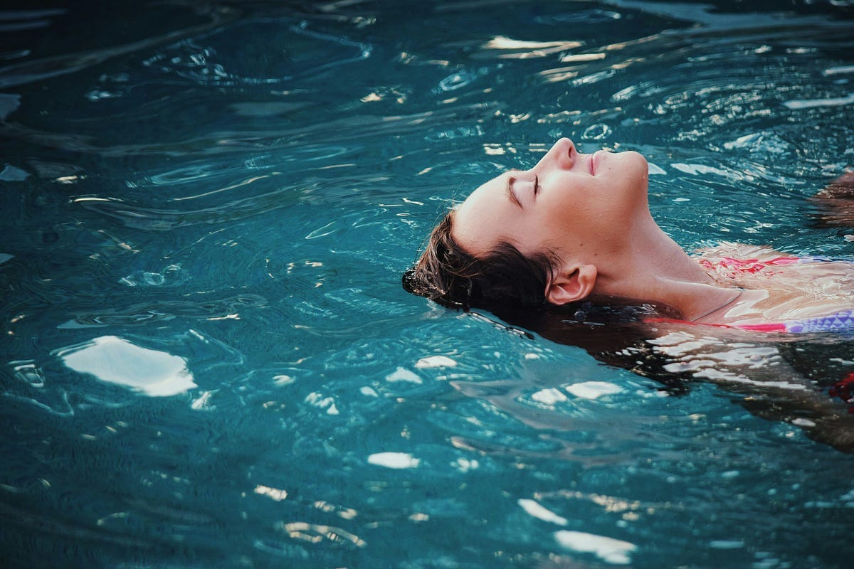 Person swimming in pool Person swimming in pool