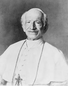 A half-length portrait of a man in white priestly robe and a crucifix around his neck. A half-length portrait of a man in white priestly robe and a crucifix around his neck.