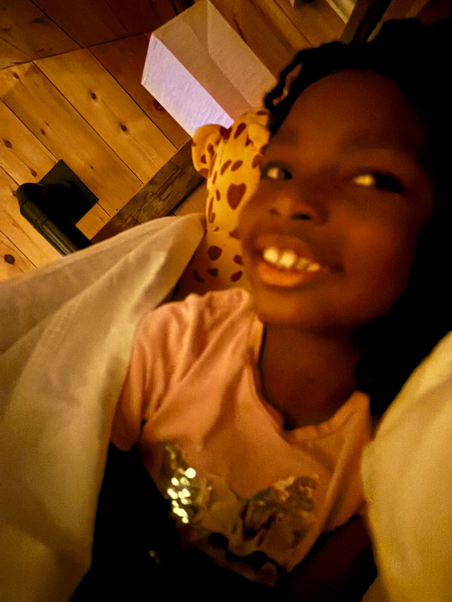 a black girl sleeping a barn smiles at the camera