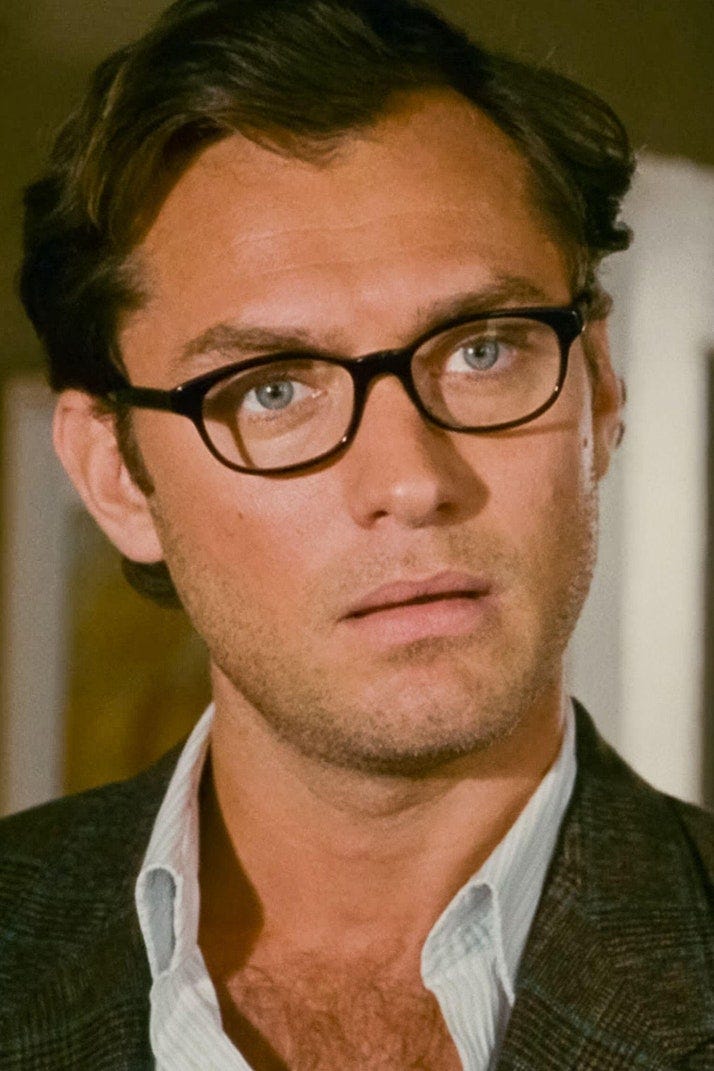 Image may contain Jude Law Face Head Person Photography Portrait Accessories Glasses Adult Cup Happy and Smile