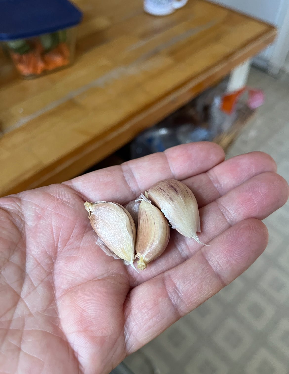 Three cloves of garlic in the palm of my hand.