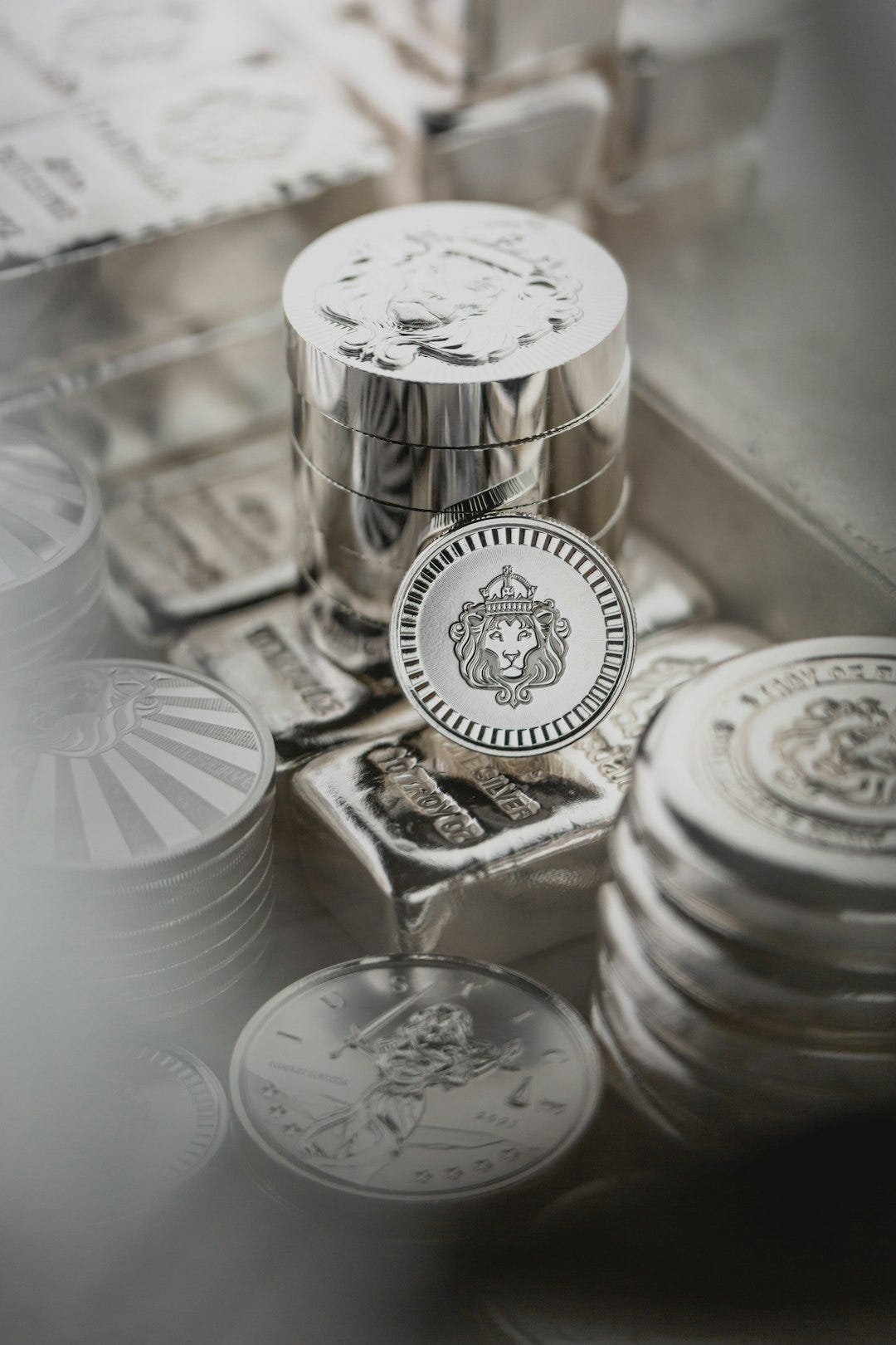 a pile of silver coins sitting on top of a table