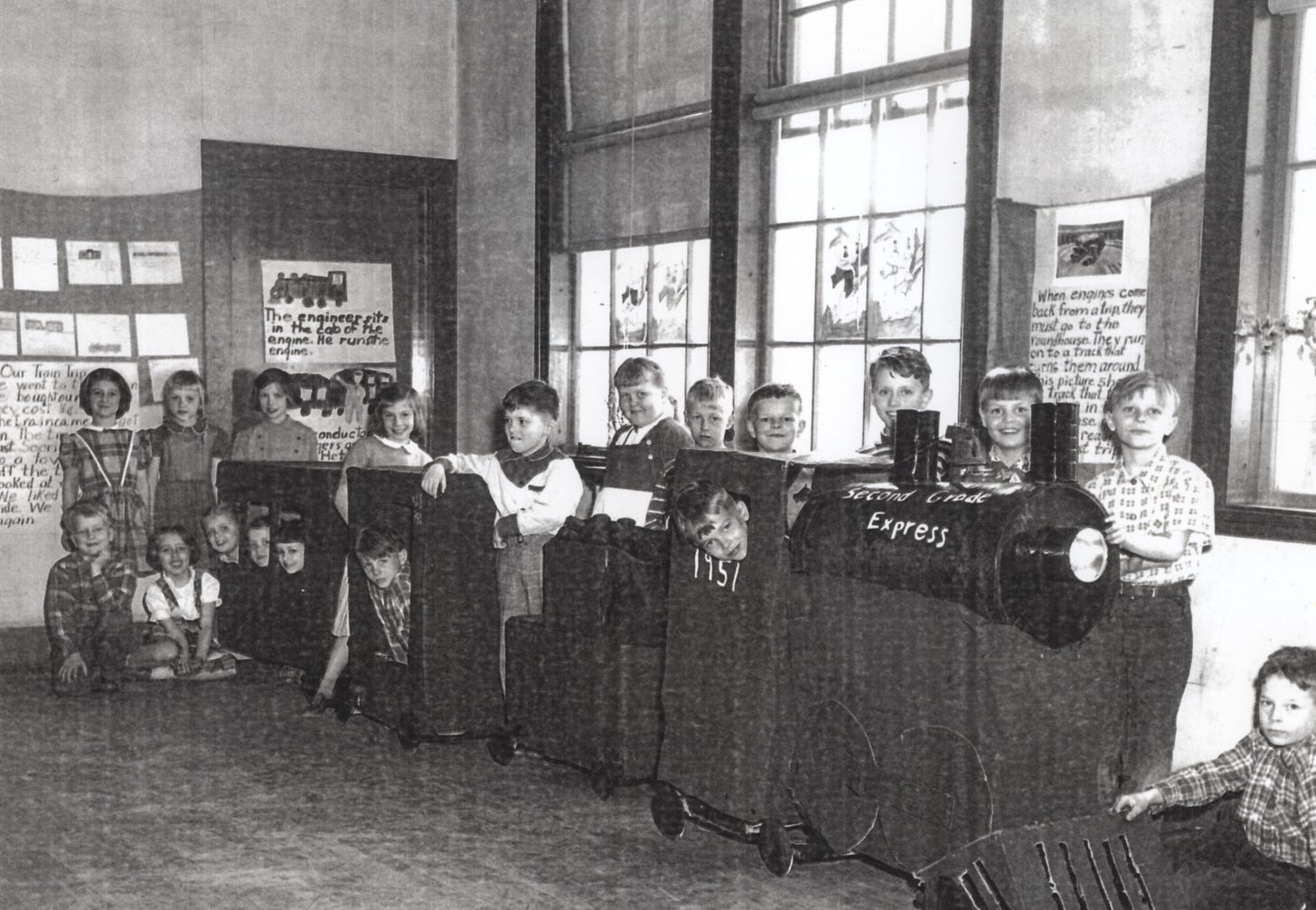 Second grade students with model of a train