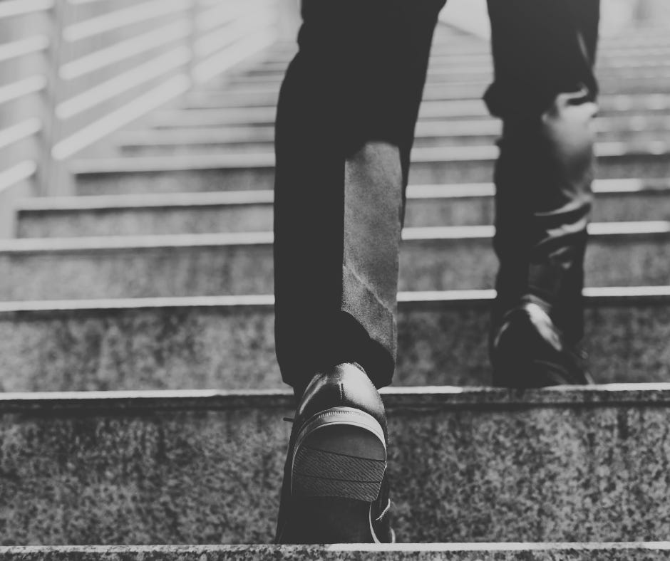 Man walking up stairs.