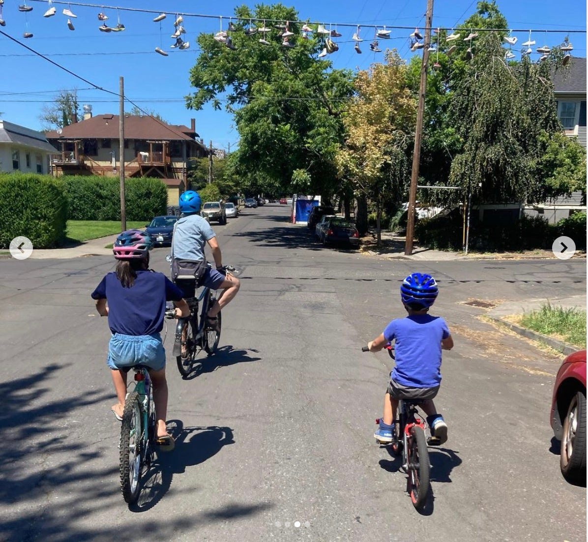 A photo taken by Nicolai which captures her husband, son and daughter all riding their own bikes on a residential street in Portland