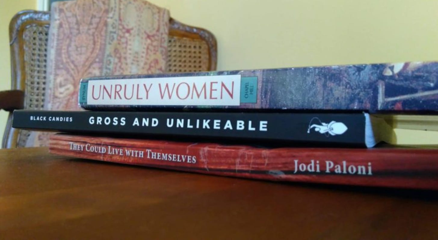 three books stacked so titles on spines make a poem unruly women gross and unlikeable they could live with themselves