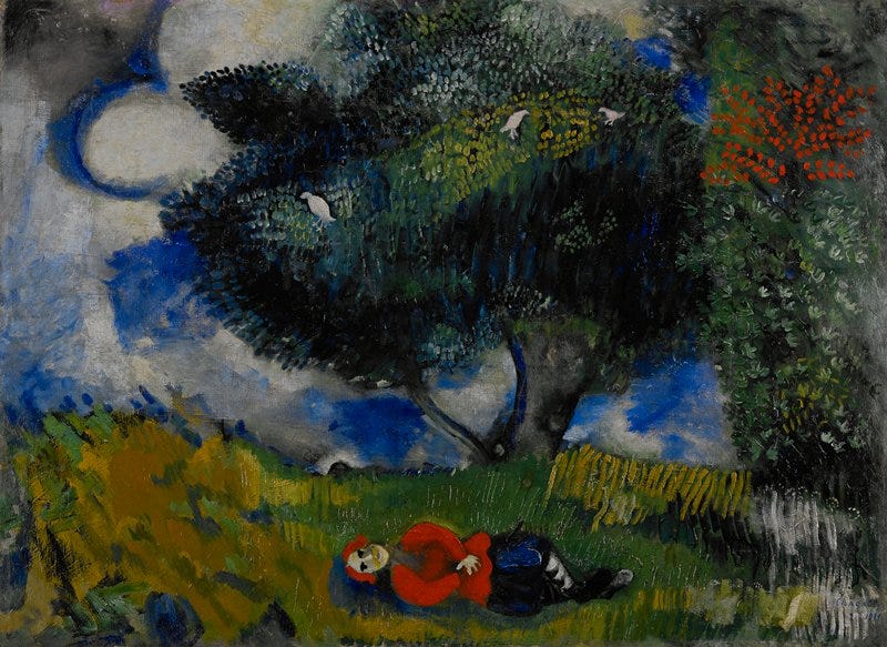 A picture of the oil painting "The Poet with the Birds", by Marc Chagall. It depicts a figure in a striking red jacket laying on the grass looking above at the trees where white birds sit. Fluffy white clouds dot a cobalt blue sky.