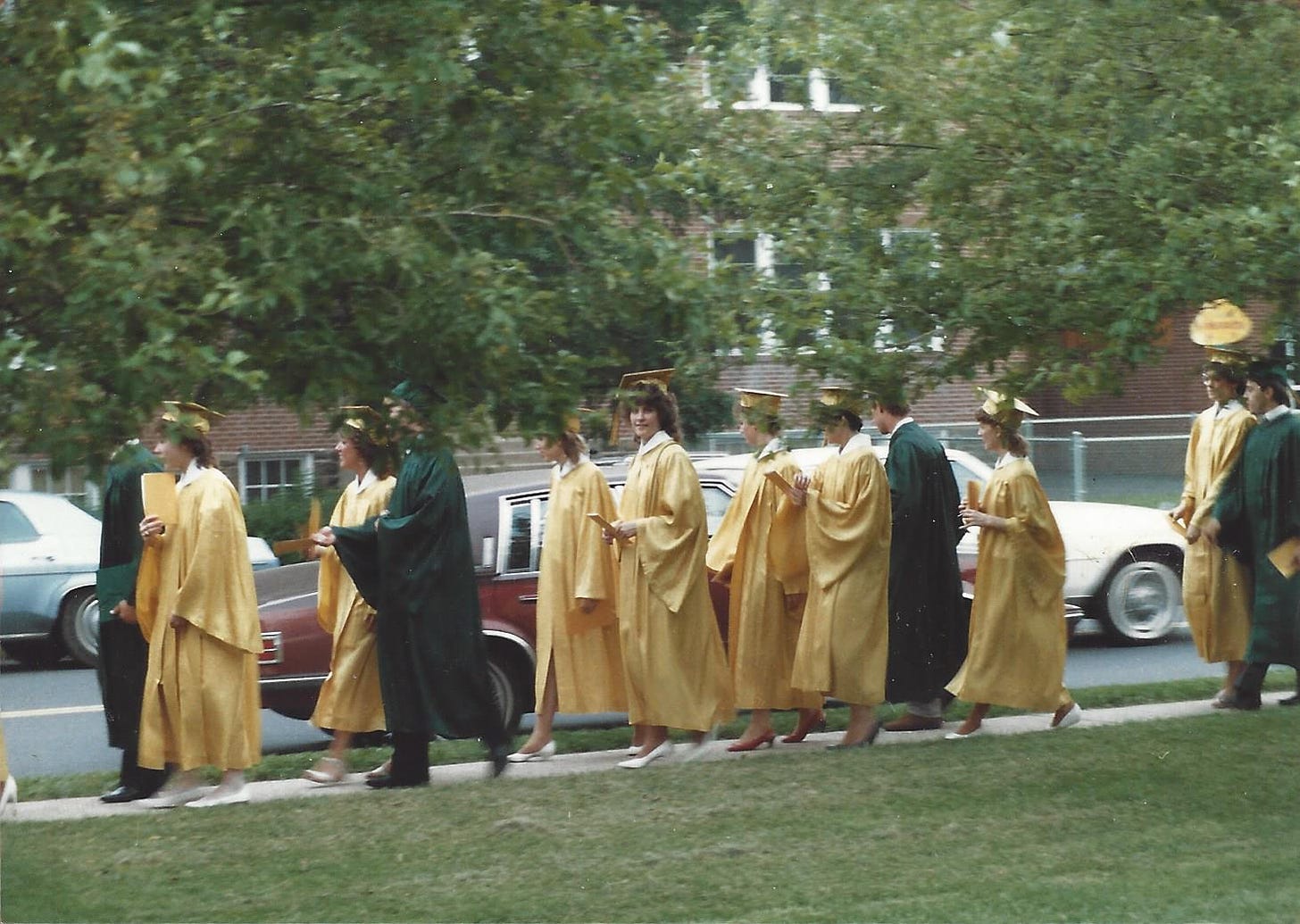 High school students in caps and gowns processing into graduation ceremony