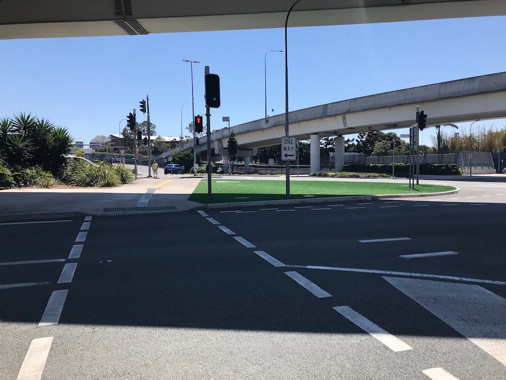 photo of intersection with a large area of fake grass in the centre