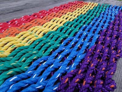 a photo of a rainbow rope woven mat
