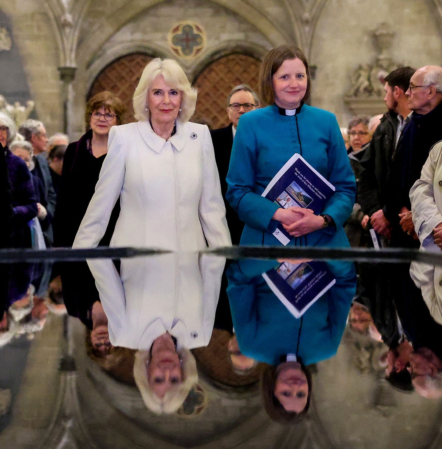 Camilla stood in front of the reflecting pool in Salisbury Cathedral