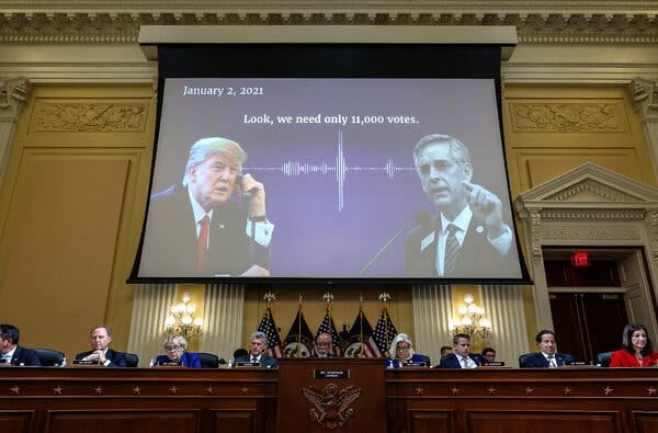 A screen with images of Donald Trump and Brad Raffensperger, and the words “Look, we need only 11,000 votes," hangs in a stately committee room above a row of seated lawmakers. 
