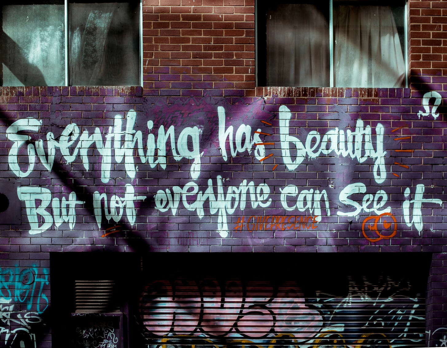 quote spray painted on brick wall: everything has beauty but not everyone can see it