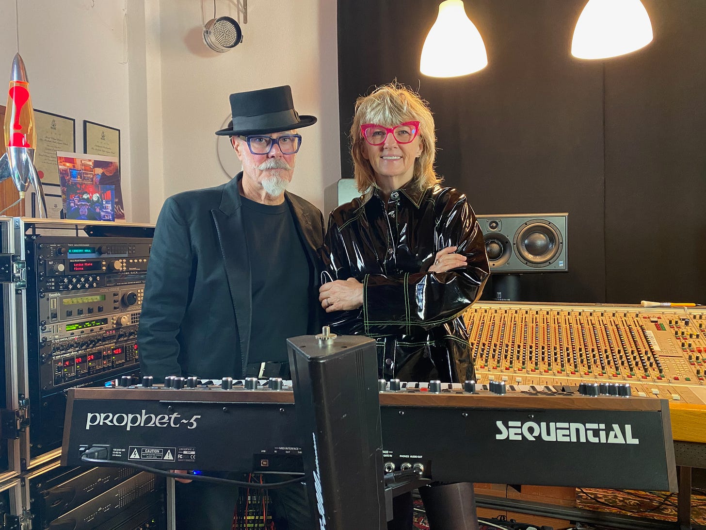 Man with top hat and great moustache, woman with pink glasses and black vinyl coat in a recording studio  - Suzy Starlite and Simon Campbell, Portugal