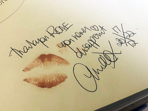 Handwritten text reads ‘Thank you RONE you never disappoint’ with a signature, date and lipstick kiss.