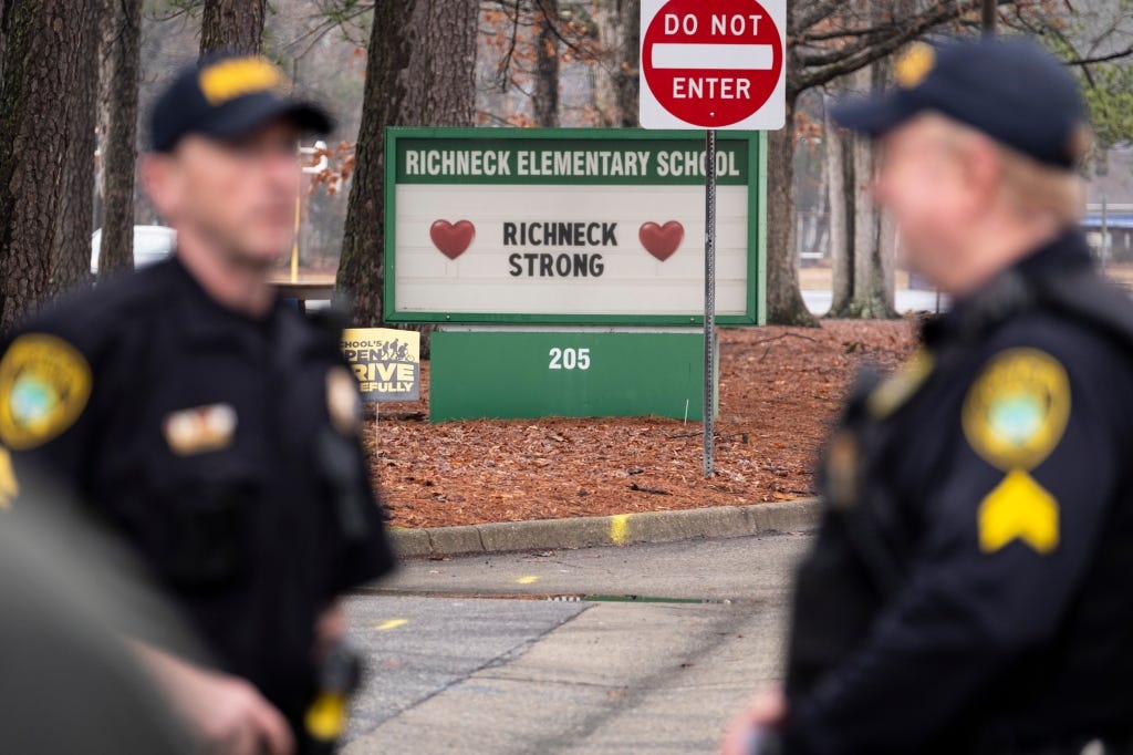 Police look on as students return to Richneck Elementary in Newport News in January.