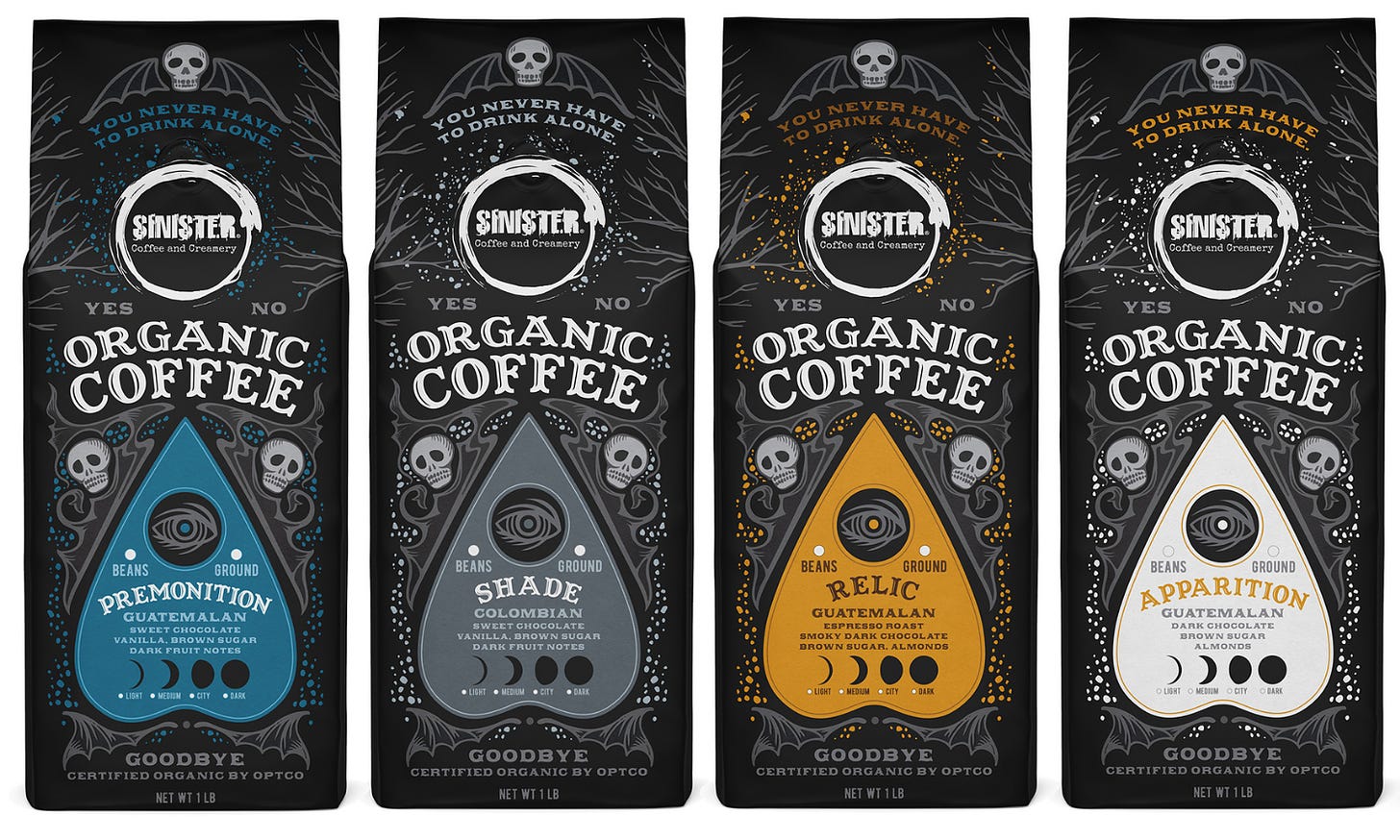 Side by side coffee bags with front view. A hand drawn gothic image featuring skulls and wings creates an homage to the Ouija board. The coffee details are outlined inside board indicator that is a different color on each bag.