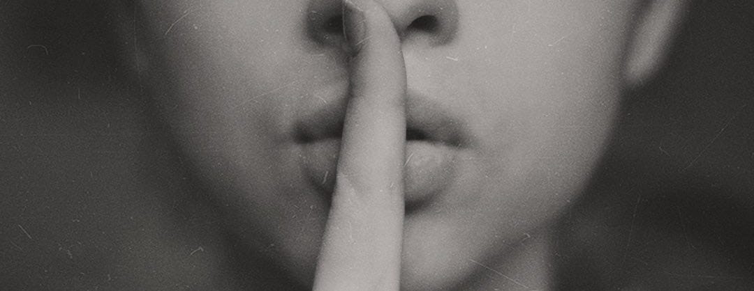 grayscale photo of woman doing silent hand sign