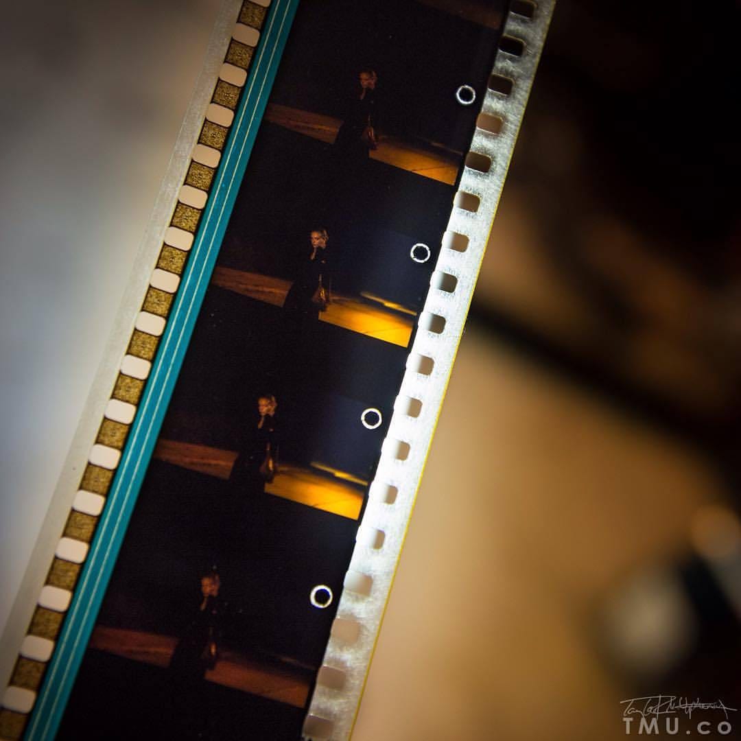 Photo of a strip of 35mm film with cue dots in the upper right corner of 4 frames. 