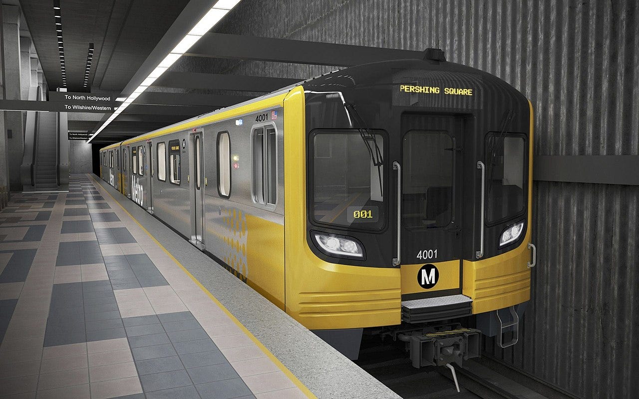 Stainless steel subway car with black and yellow nose