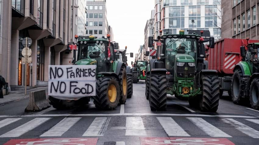 Farmers protesting in Brussels. The sign on the tractor reads "No farmers, no food".