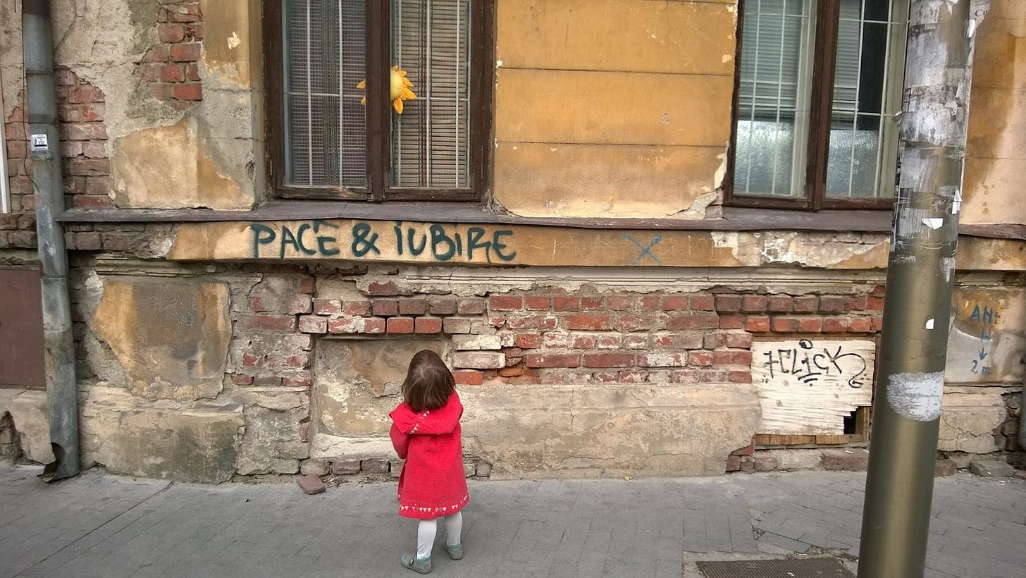 A child standing in front of a building

Description automatically generated