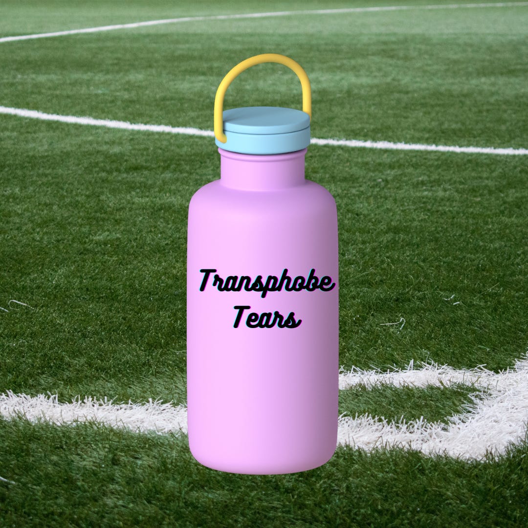 a purple water bottle with the words "transphobe tears" written on it in black lettering on a sports field