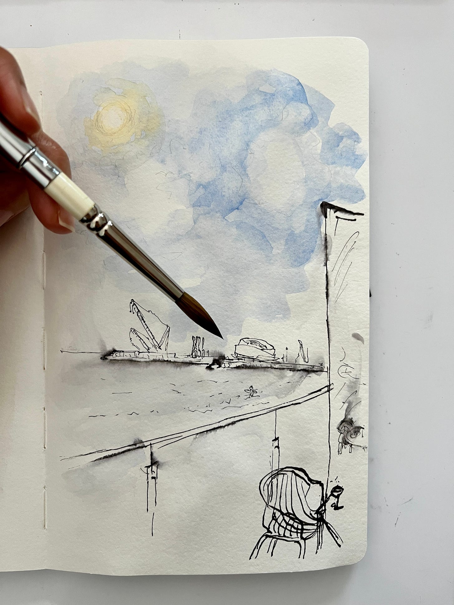 image: loose ink and watercolour sketch from a point of view of sitting outside a beachfront cafe with huge expanse of blue sky