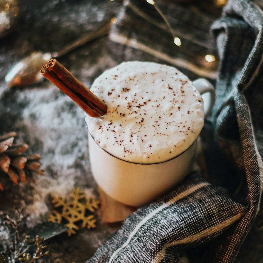 white liquid in clear glass cup