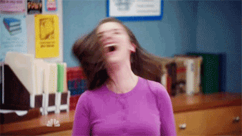 Woman in a purple sweater shaking her head and screaming out of frustration