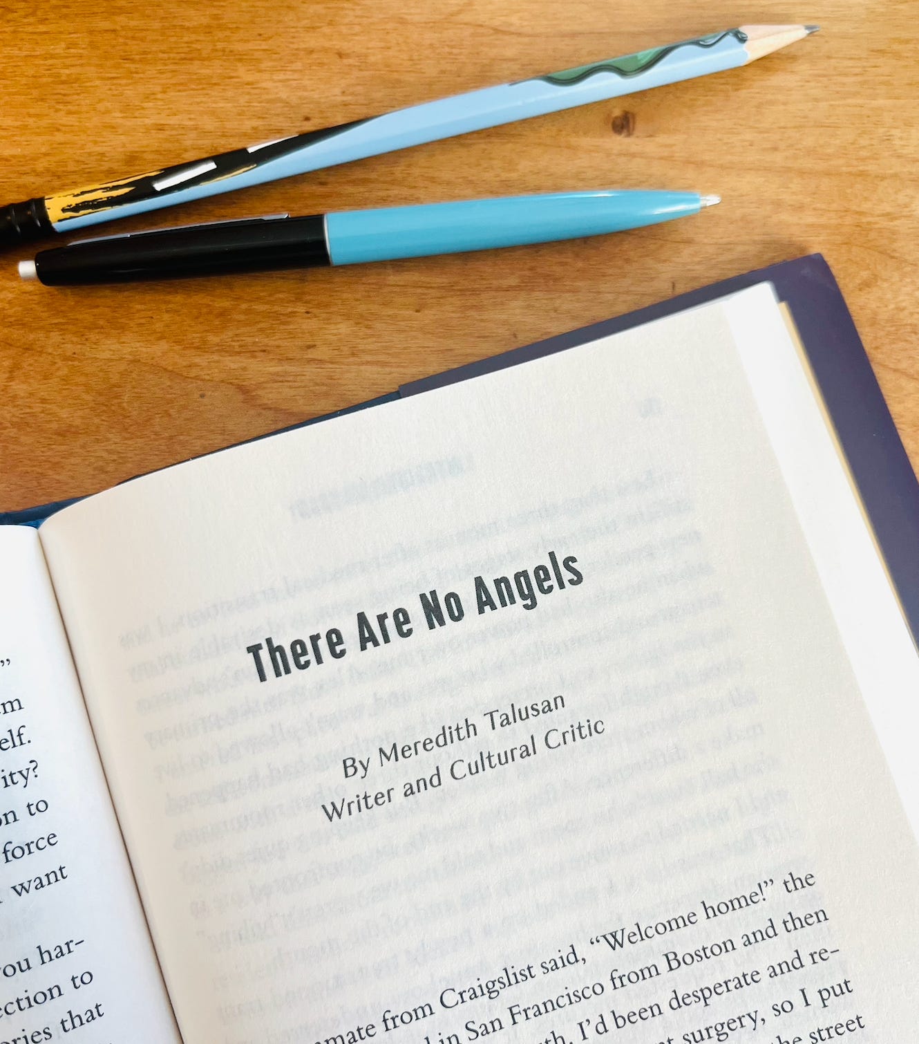 A book opened to the title page of the essay "There Are No Angels" by Meredith Talusan