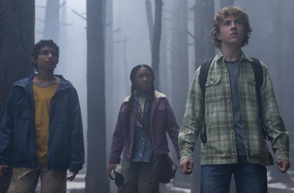 Grover, Annabeth, and Percy from Percy Jackson and the Olympians standing outdoors in a foggy forest