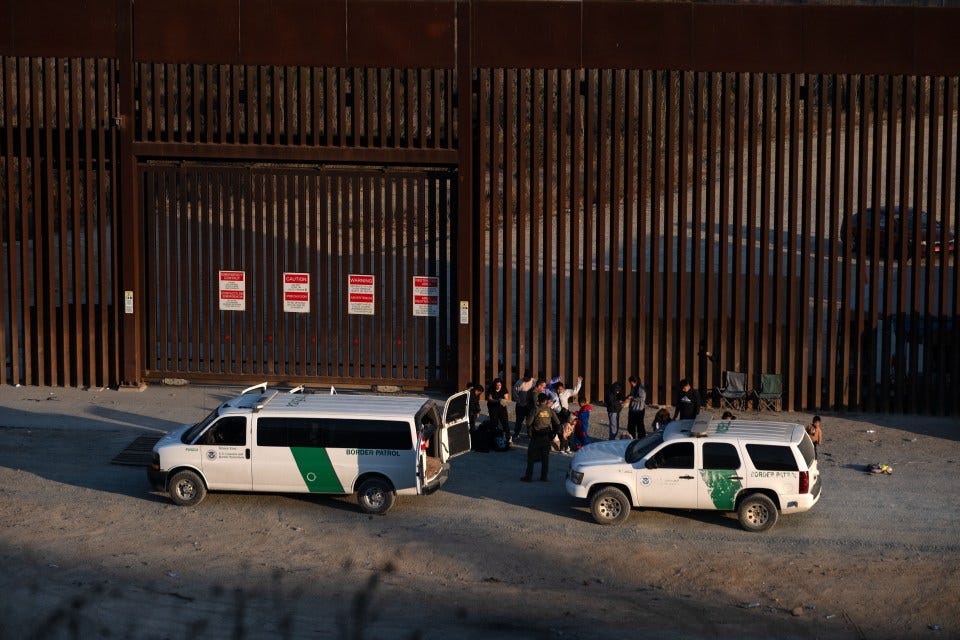 Migrants at the US-Mexico border being processed by Border Patrol agents. Migrants at the US-Mexico border being processed by Border Patrol agents.
