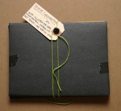 Black envelopes tied together with green string and a label that reads "Positive Consumption"