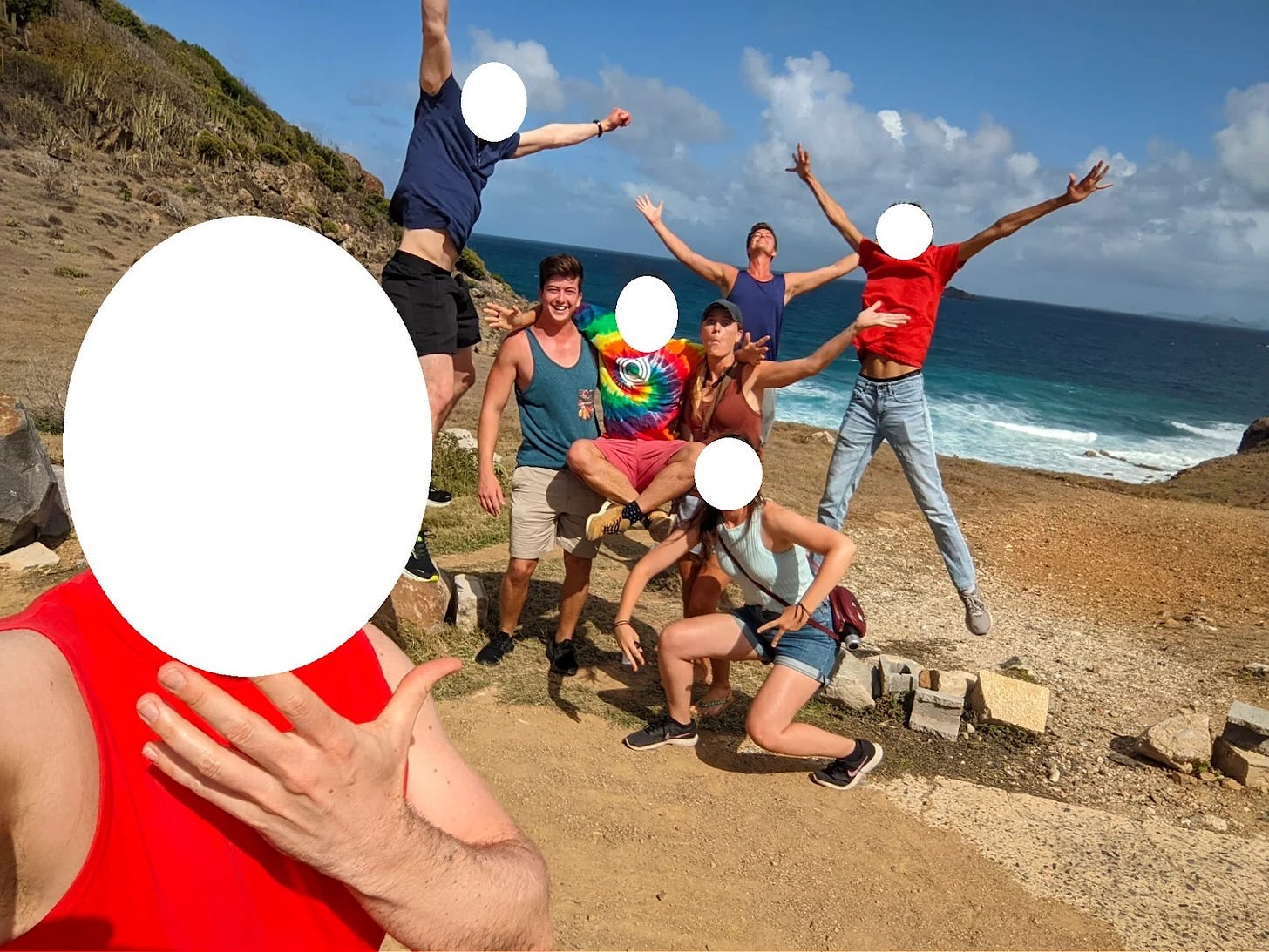 Group photo of cartoonishly exuberant people on a beach. Most faces have been whited out, but three are Nonlinear employees.