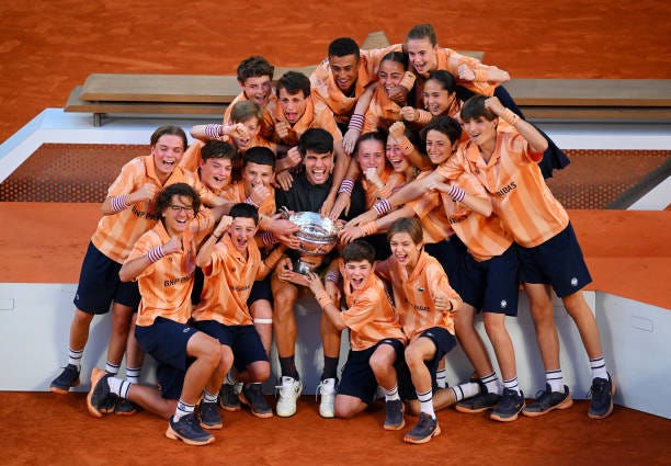 Carlos Alcaraz of Spain celebrates with the winners trophy with ball kids after victory in the Men's Singles Final match between Alexander Zverev of...